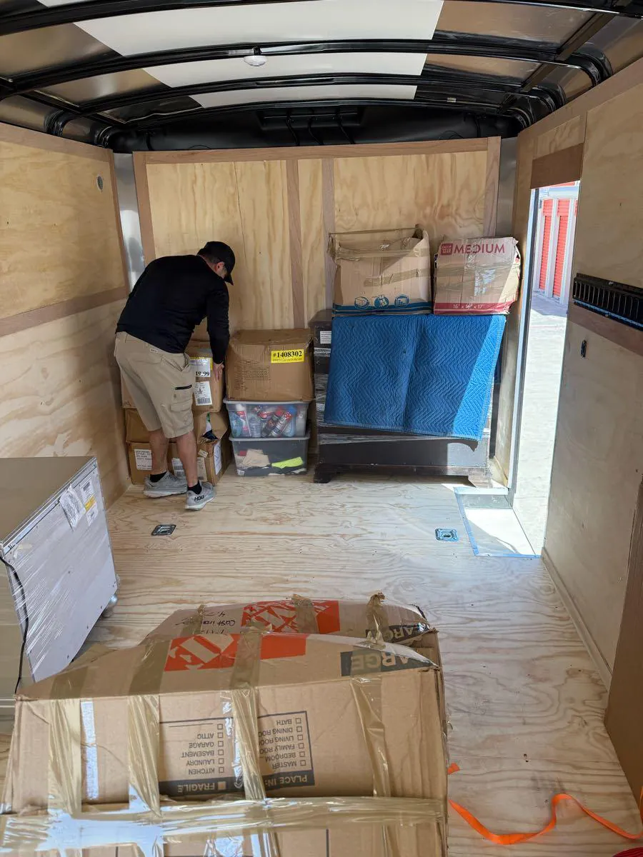 A crew member loading boxes into the trailer