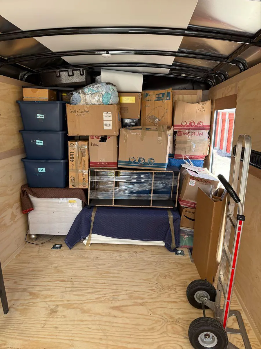 The plywood-lined trailer loaded with bins, boxes and wrapped furniture